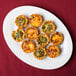 A Tuxton Alaska china platter with mini quiches with cheese and broccoli.