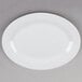 A Tuxton Alaska white china platter with a wide rim.