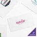 A white Choice dinner napkin with red text that says "Savor"