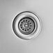 A close-up of a Regency stainless steel wall-mounted hand sink drain.