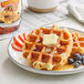A plate of waffles with Cary's Sugar Free Pancake and Waffle Syrup on top.
