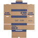 A brown cardboard box with blue text that reads "Controltek USA Blue Coin Box" containing blue coin wrappers.