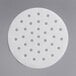 A white Garde circular patty paper with holes.