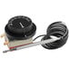 A black and white thermostat dial with a wire.