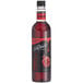 A close up of a bottle of DaVinci Gourmet Classic Grenadine flavoring syrup with a red cap filled with red liquid.