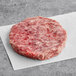 A raw TenderBison 80/20 Bison Burger on a white napkin.