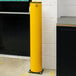 A yellow A-Safe iFlex bollard with a black base and wear collar.