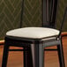A white vinyl cushion designed for alloy barstools.