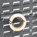 A Quantum horizontal metal rack holding a roll of tape.
