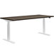 A HON Florence Walnut and Designer White desk with white legs.