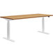A HON Coze Coordinate natural recon and white desk with white legs.