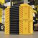 A yellow and black A-Safe FlexiShield column guard.