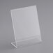 A clear plastic stand holding a white sign.