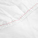 A white fabric with red stitching.