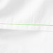 A Monarch Brands white cotton/polyester king size flat sheet with green stitching.