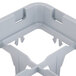 A grey plastic Cambro shelf extender with compartments and holes.