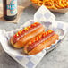 Two Nathan's Famous beef hot dogs with ketchup and mustard on them.
