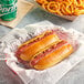 Nathan's Famous beef hot dogs in a paper basket with fries and soda.