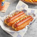 Two Nathan's Famous beef hot dogs in a basket.