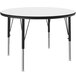 A white round Correll activity table with black legs.