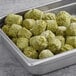 A metal tray filled with Grecian Delight Falafel Fritters.