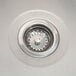A close-up of a stainless steel sink drain.