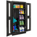 A black Hallowell combination cabinet with Safety-View doors holding cleaning supplies.