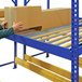 A man holding a box on a blue steel pallet rack shelf.