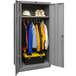 A grey metal Hallowell wardrobe cabinet with solid doors filled with clothes and tools.