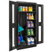 A black Hallowell combination cabinet with Safety-View doors storing cleaning supplies.