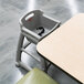 A Rubbermaid platinum high chair with wheels and a baby seat.