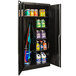 A black metal Hallowell combination cabinet with solid doors filled with cleaning supplies.