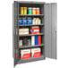 A Hallowell gray metal storage cabinet with shelves full of items.