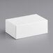 A Baker's Mark white rectangular bakery box on a gray surface.
