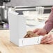 A person opening a white pie box.