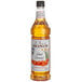 A close up of a bottle of Monin Premium Salted Caramel Flavoring Syrup with a white label.