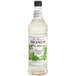 A white Monin bottle of liquid labeled "Monin Premium Frosted Mint Flavoring Syrup"