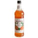 A bottle of Monin Rock Melon Cantaloupe syrup with a label.