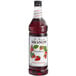 A Monin bottle of strawberry syrup.