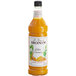 A close up of a bottle of Monin Premium Golden Turmeric syrup.