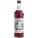 A close up of a Monin blueberry syrup bottle.