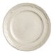 An Acopa Condesa warm gray porcelain plate with a scalloped rim.