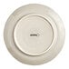 An Acopa Condesa warm gray porcelain plate with a scalloped rim and black text on it.