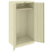 A white metal Tennsco wardrobe cabinet with a door open.