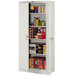 A light gray Tennsco storage cabinet with solid doors filled with boxes.