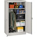 A light gray Tennsco standard combination cabinet with solid doors and items on the shelves.