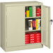 A Tennsco putty metal storage cabinet with solid doors open.
