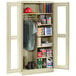 A Tennsco putty metal combination cabinet with open doors.