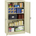 A Tennsco standard storage cabinet with many boxes on the shelves.