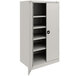 A light gray Tennsco metal storage cabinet with shelves.